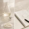 LUMIADE formula lab LUMIADE formula development still life with skincare textures and lab glass