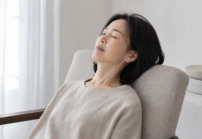 Woman resting with eyes closed in soft midday light