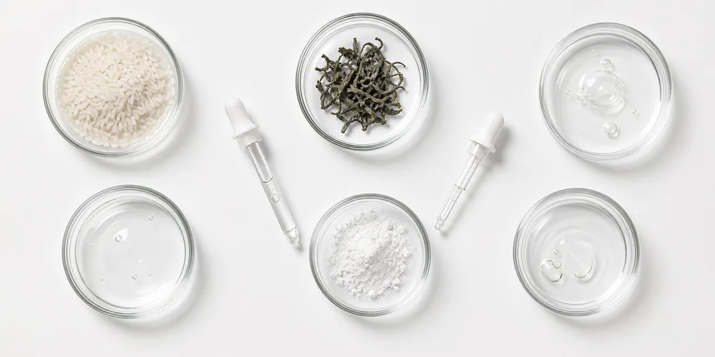 Raw skincare ingredients in small glass dishes, viewed from above